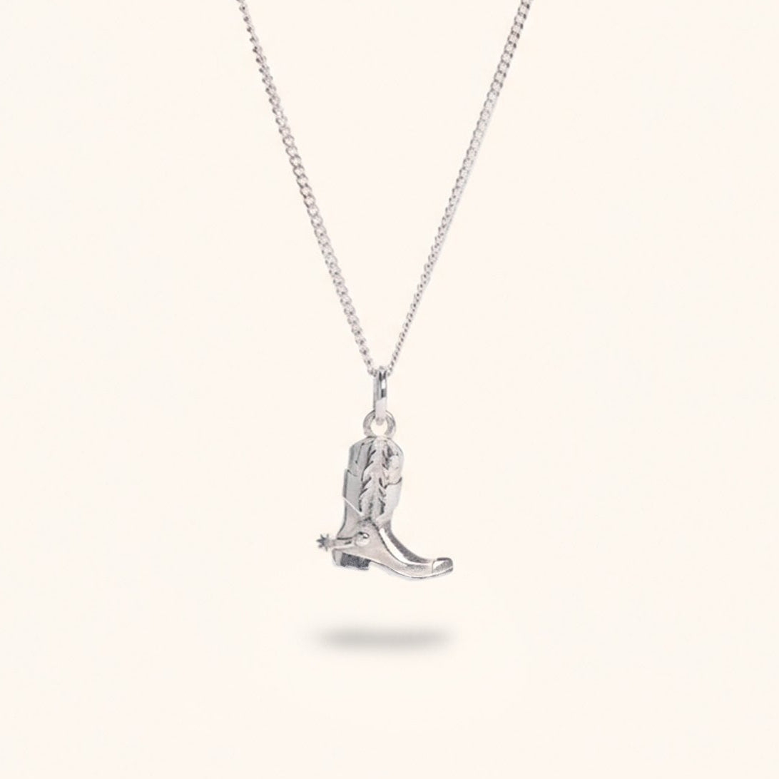 Prairie silver cowboy boot charm necklace flat lay – handmade jewellery Finland