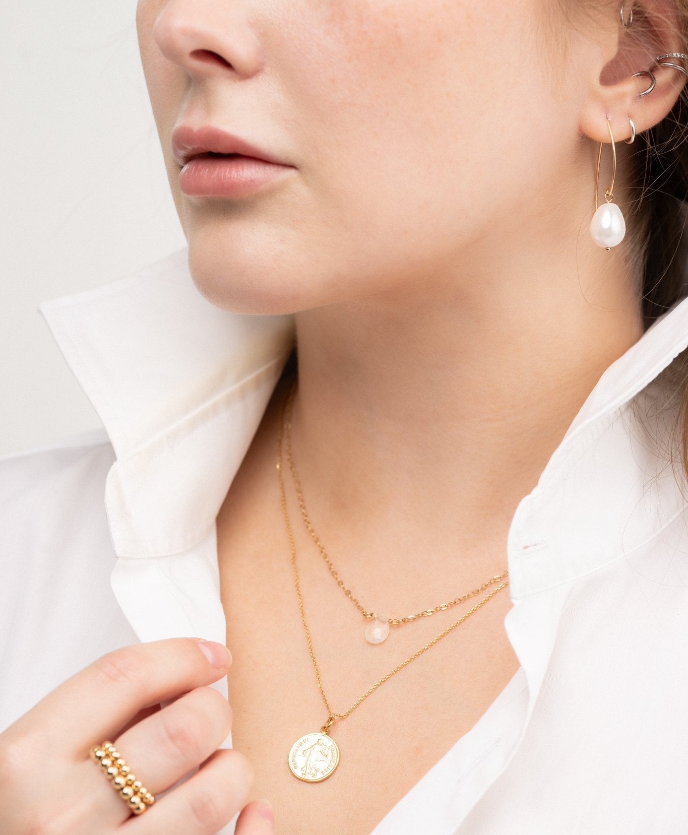 Arina gold-filled shell pearl earrings on model – handmade minimalist jewellery Finland
