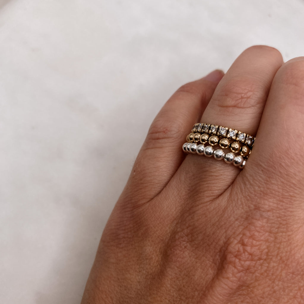 Barbel silver and gold bead rings stacked on hand – Omasi Collection