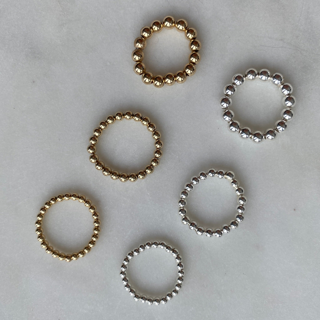 Barbel silver and gold-filled bead rings together flat lay – Omasi Collection