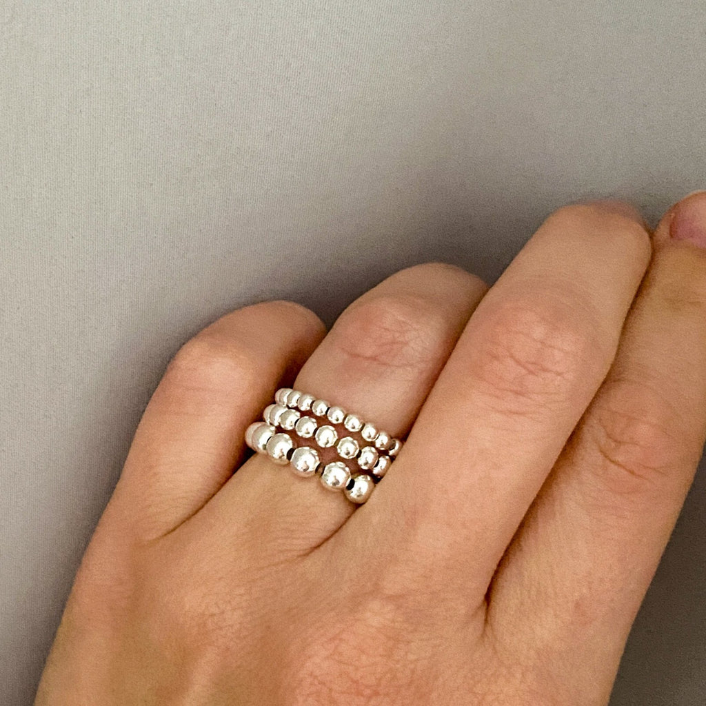 Barbel silver bead rings stacked on hand – Omasi Collection