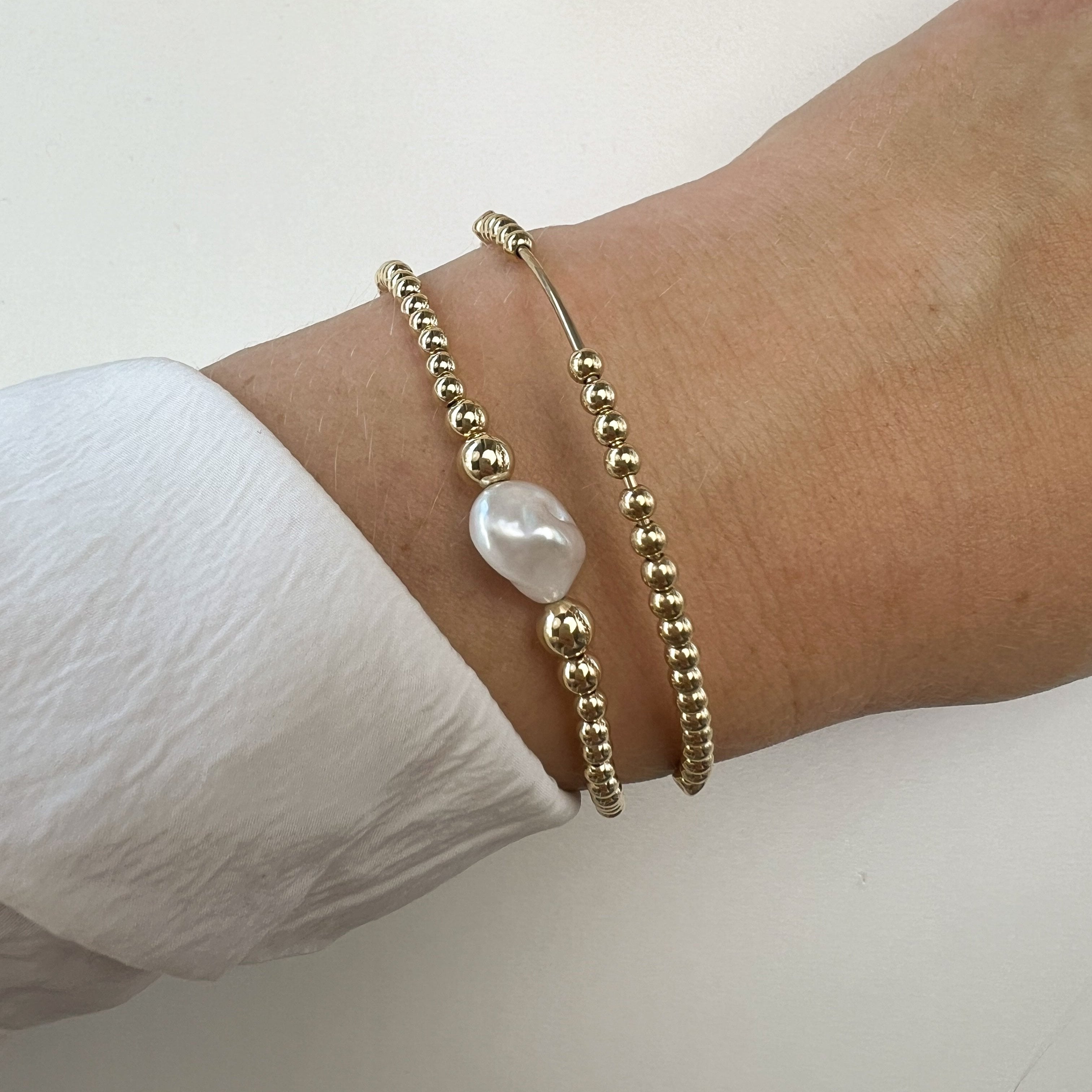 Belle gold-filled pearl bracelet stacked with Aura on wrist – Omasi Collection