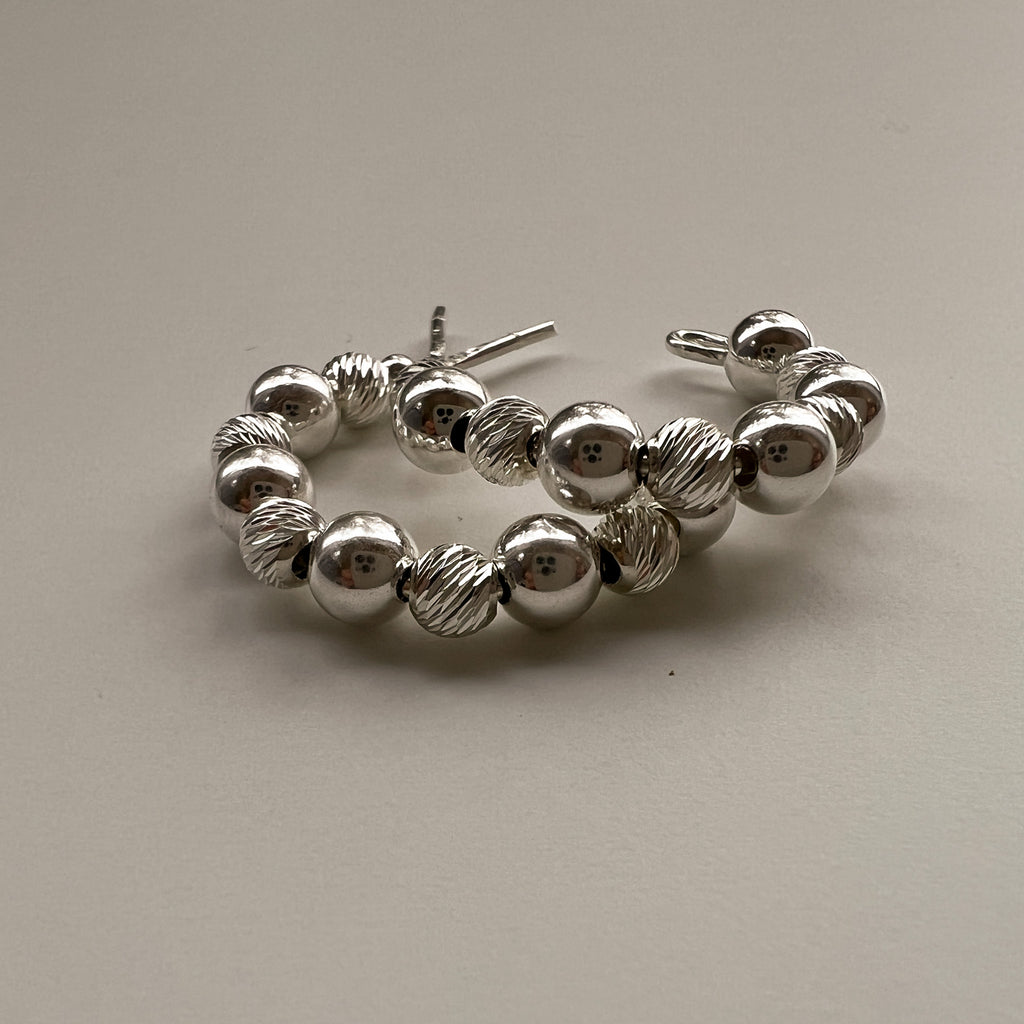 Ilona 20mm silver c-hoop earrings flat lay – Omasi Collection Finland