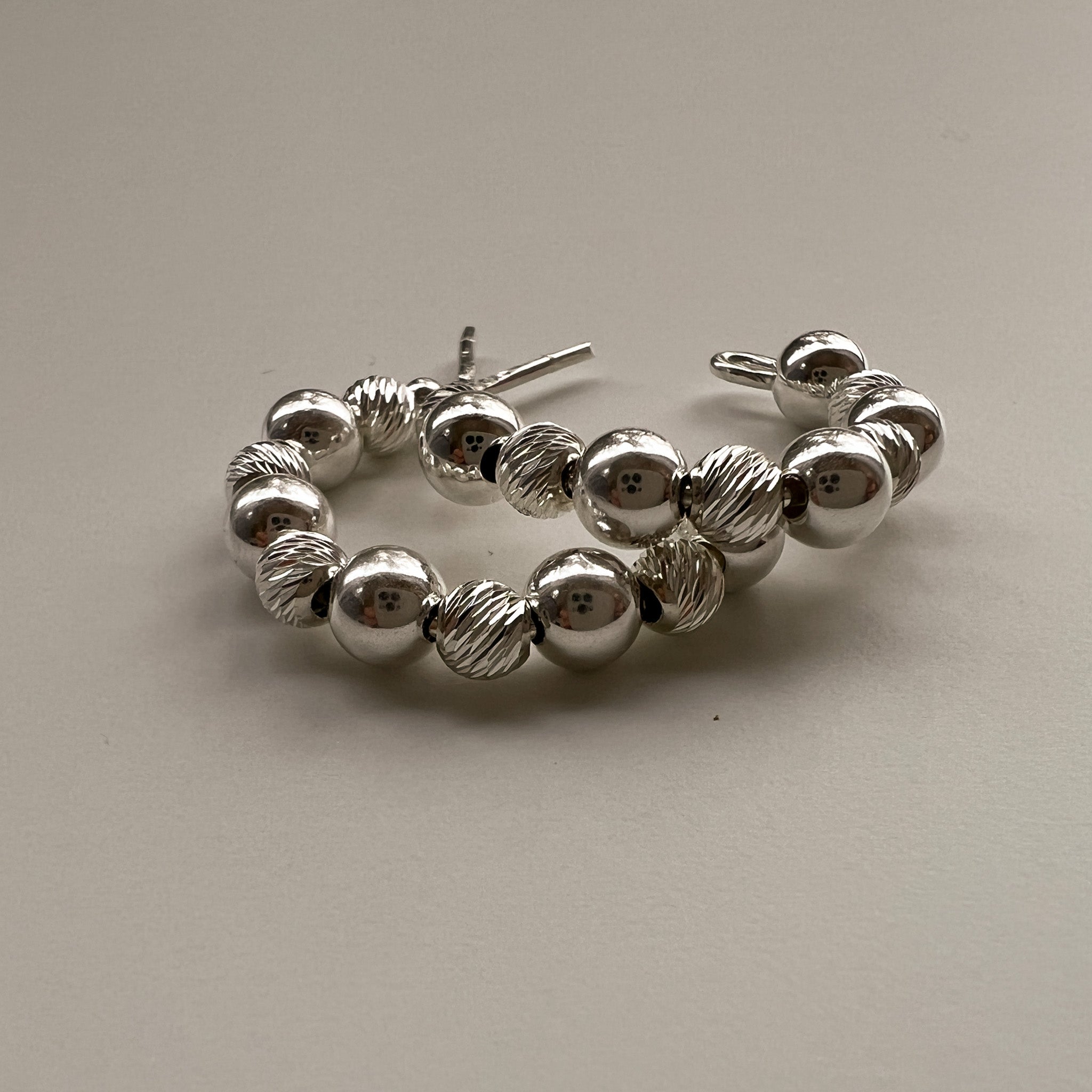 Ilona 20mm silver c-hoop earrings flat lay – Omasi Collection Finland