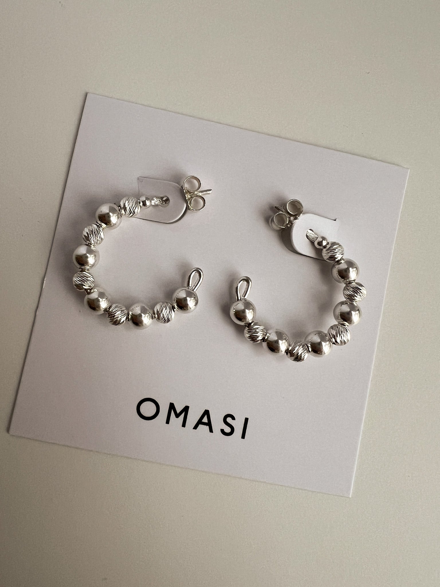 Ilona 20mm silver c-hoop earrings flat lay 2