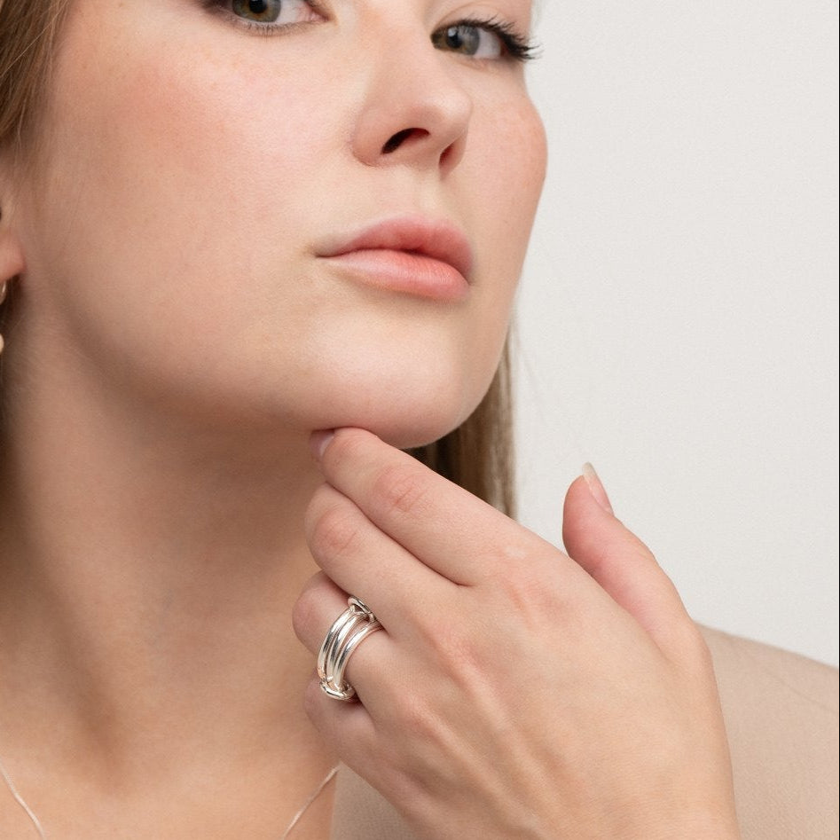 Isola sculptural sterling silver ring on model – handmade jewellery Finland