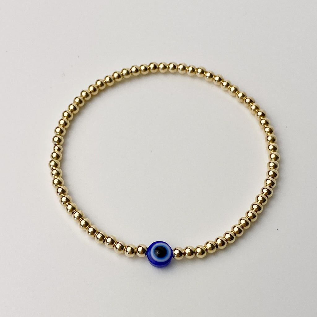 Nazar gold-filled evil eye bracelet flat lay – Omasi Collection Finland