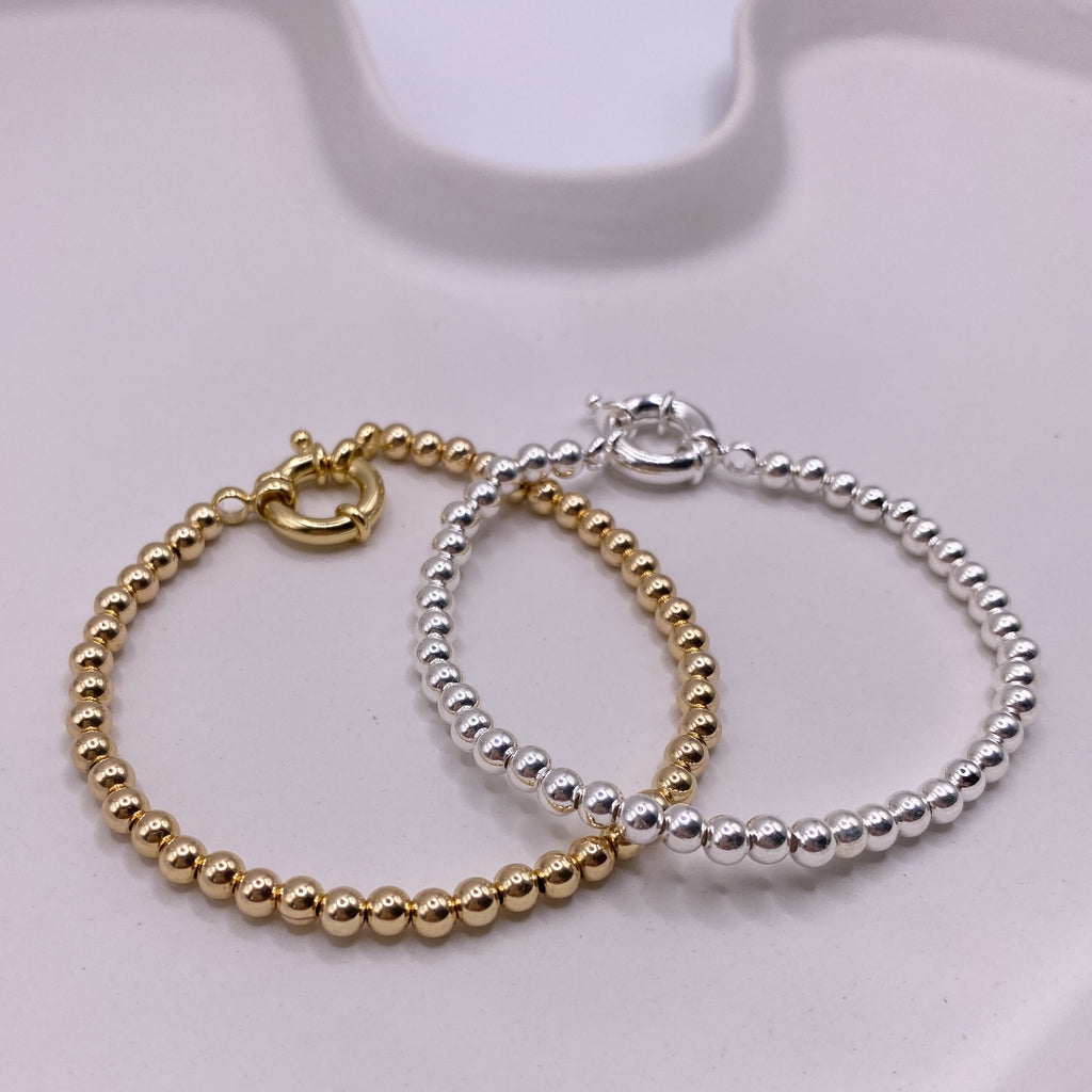 Solme silver and gold bracelets together flat lay – Omasi Collection