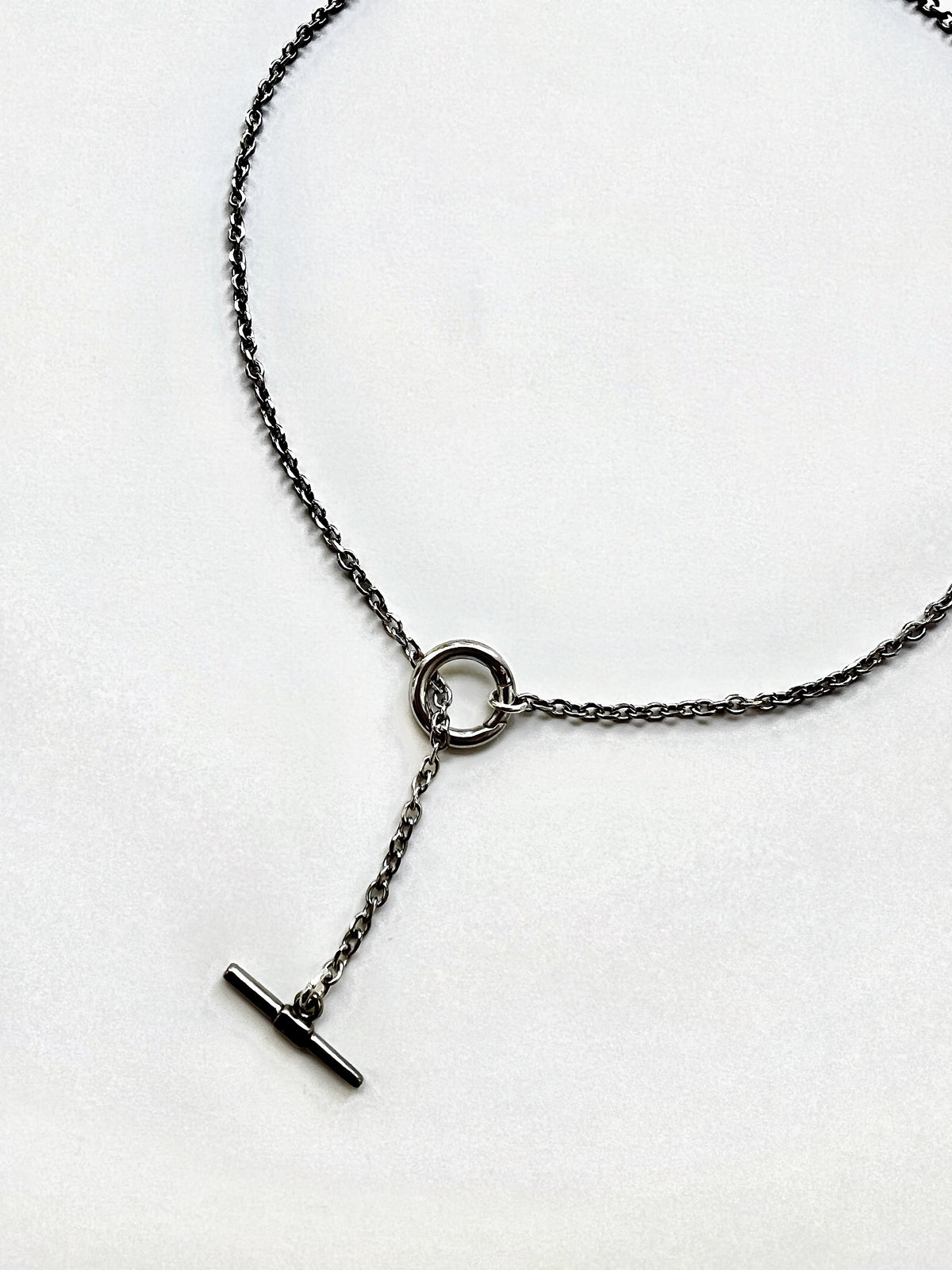 Mova silver tone loop necklace, close-up of the ring and T-bar drop in nickel-free surgical steel – Omasi Collection