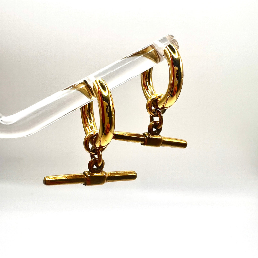 Mova silver tone T-bar hoop earrings hanging on a clear acrylic stand – Omasi Collection